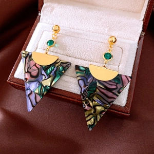 Detail view of triangular resin earrings with colorful marble texture in a jewelry box