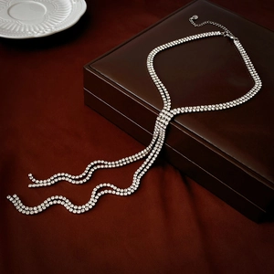 Detailed macro view of double-layered silver rhinestone chain with elegant long tassels