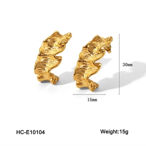 Detailed view of textured gold leaf-shaped earrings with 30mm height and 15g weight specs