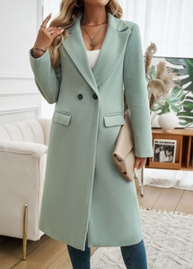 Detail of light green wool coat featuring lapel collar, double-breasted buttons and pockets