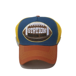 Detail of rugby team embroidery on a vintage trucker hat with mesh back panel