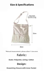 Detail of pink striped tote bag showing bow decoration and adjustable shoulder strap