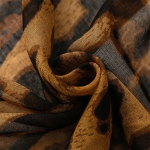 Macro shot of lightweight leopard print fabric showing fine woven texture and fibers
