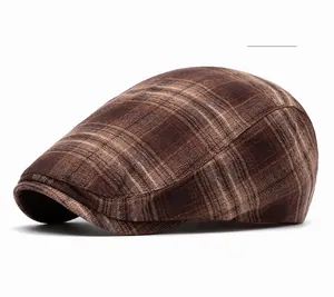 Close-up of brown plaid flat cap showing thick blended fabric and classic twill texture