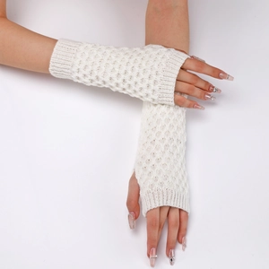 Close-up of white cable knit fingerless gloves showing texture and thumb hole detail