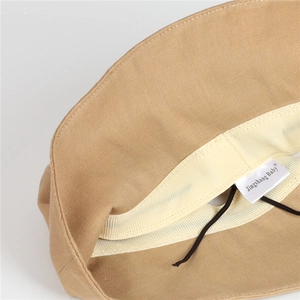 Detail view of khaki sun hat interior with sweatband, adjustable drawstring and fabric label