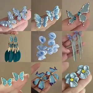 Parure de boucles d'oreilles papillon bleu avec strass et pompons en plumes pour femmes