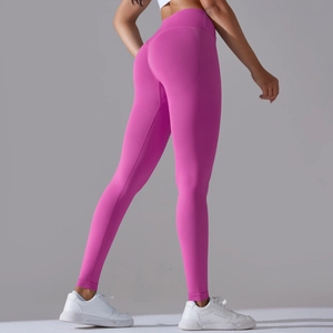 Macro detail of the seamless high waist and peach butt lift design on pink yoga leggings