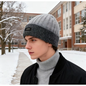 Detailed knit texture of grey beanie with LA&DH woven label in outdoor snow scene