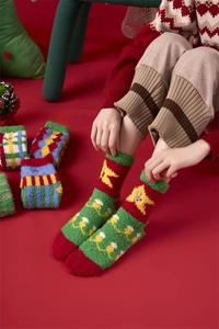 Detail of warm coral fleece Christmas socks featuring reindeer patterns and plush texture