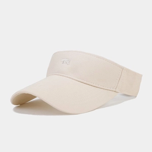 Detailed close-up of beige sun visor with polar bear embroidery and cotton texture