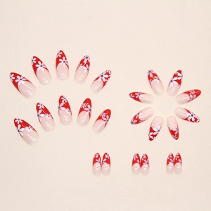 Faux ongles amande French rouges avec motifs marguerites blanches et détails