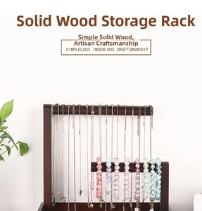 Detail of dark wood jewelry stand with two tiers for hanging necklaces and bracelets