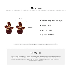 Detail view of red flower earrings with pearls and dimensions on a white background