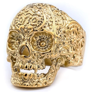 Detailed macro of golden skull ring with vintage embossed sugar skull patterns