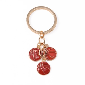 Golden keychain featuring three red enamel basketball pendants for sports enthusiasts