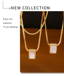 Detailed macro shot of vintage gold snake chain and rectangular white shell pendant