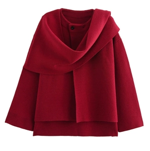 Detail of burgundy short knit jacket with asymmetrical scarf overlay and single black button