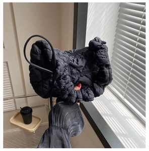 Handheld black quilted cloud bag made of soft down cotton with rhombus stitching detail