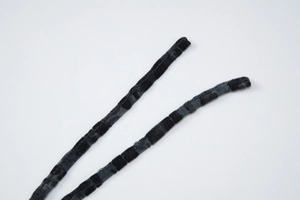 Detailed macro view of black velvet and mesh straps with textured square pattern weave