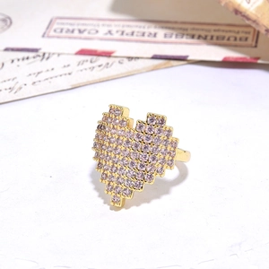 Macro detail of gold plated ring featuring a pixel heart set with purple zircon stones