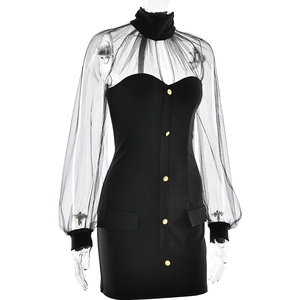 Detail of sheer mesh patchwork on black slim fit dress with golden button accents