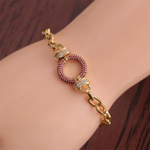 Detail of hip hop gold chain bracelet with micro-pave purple and white zircons on wrist