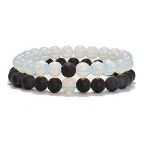 Detailed view of 8mm natural stone stretch bracelets in matte black and opal white beads