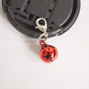 Vibrant red metal bell pendant with silver lobster clasp on a clean white background