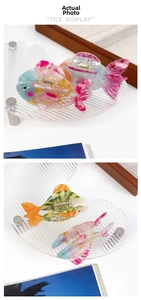 Detailed view of colorful goldfish hair claws showing acetate texture and metal spring