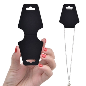 Close-up of black foldable cardboard display cards for necklaces and earrings