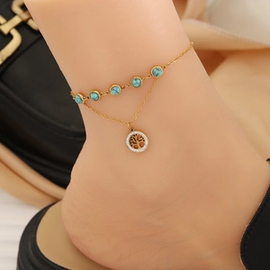 Gold double-layered anklet featuring turquoise stones and a sparkling Tree of Life charm