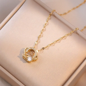Detailed shot of gold horseshoe pendant with shimmering zircon in a jewelry box