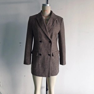 Close-up of classic houndstooth pattern and double-breasted buttons on this mid-length blazer