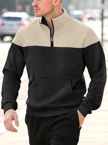 Outdoor shot of men's two-tone half-zip hoodie with corduroy texture and quilted shoulders
