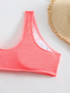 Close-up of pink seersucker bikini top with textured fabric and wide shoulder straps