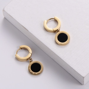 Elegant 18k gold earrings with black circular pendants featuring Roman numeral engravings