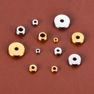 Detailed view of gold and silver stainless steel spacer beads for DIY jewelry making