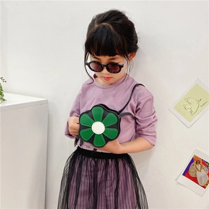 Detail of green flower-shaped PU leather crossbody bag for girls with black strap