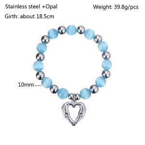 Detail showing 10mm light blue opal beads and stainless steel heart charm with feather texture