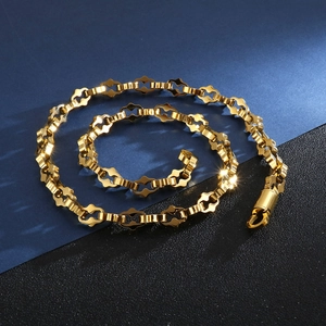 Detailed close-up of golden stainless steel geometric chain necklace with lobster clasp
