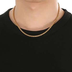Close-up of a minimalist gold twisted rope chain necklace worn on a fashion model