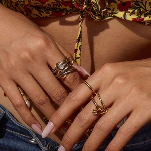 Multi-layer stacked stainless steel rings with zircon stones on a model's hand