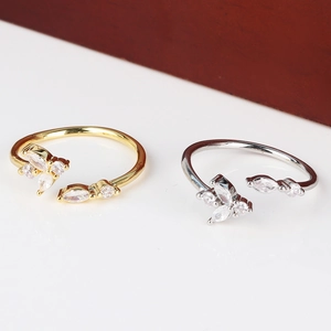 Detailed macro of gold and silver adjustable rings with sparkling marquise zircons