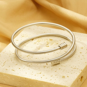 Detailed macro view of a silver double-layered spring coil stainless steel bracelet