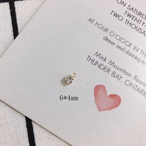 Macro detail of a 6x4mm mini rhinestone pendant with gold-plated setting and dual loops