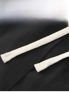 Detail view of durable white woven drawstrings on comfortable cotton black sweatpants