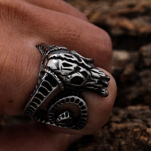 Gothic punk ram skull ring in silver stainless steel on dark wood background