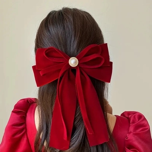 Elegant red velvet bow hair clip with pearl embellishment and long streamers for women