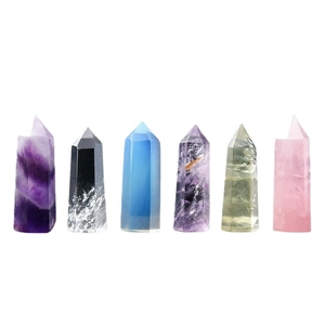 Set of six natural crystal points including amethyst and obsidian on a white background
